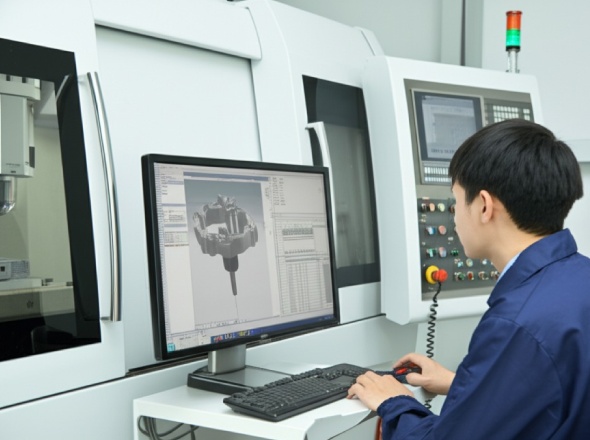 High precision 3D CNC routing machine creating intricate component