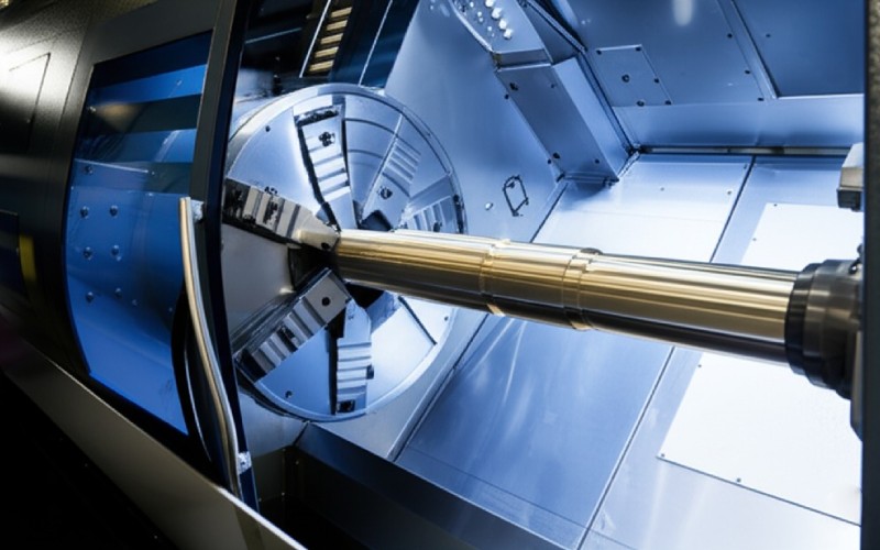 CNC lathe shaping a brass cylinder