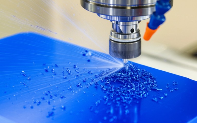 CNC machine carving blue plastic