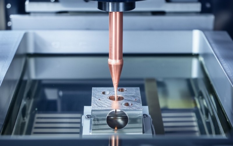 EDM machine shaping a submerged part