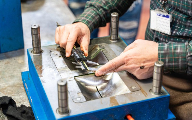 Measuring CNC part with caliper